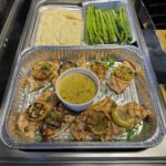 Grilled Salmon mashed potatoes and asparagus in catering foil trays
