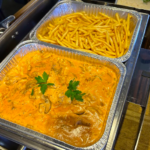 beef stroganoff with French fries in foil trays