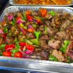 catering foil tray with beef and vegetable skewers