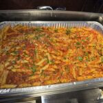 Pasta Arrabiata in a catering foil tray