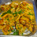 pieces of chicken in a foil tray