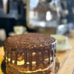 Whole Carrot and Chocolate Cake on top of wooden counter