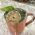 copper mug with Moscow mule drink and dry lime