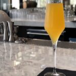 Champagne glass with passion fruit mimosa