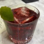 glass with drink made of cassis and Campari