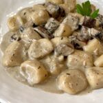 truffle mushroom pasta on a white ceramic dish