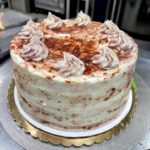 Whole Strawberry Cake on a metallic silver counter