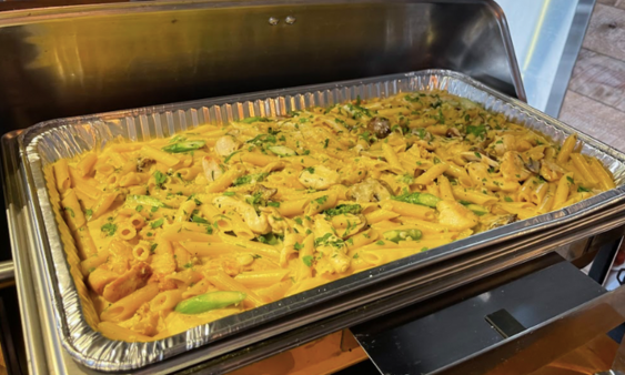 Catering foil tray in rechaud pasta with chicken mushrooms and asparagus